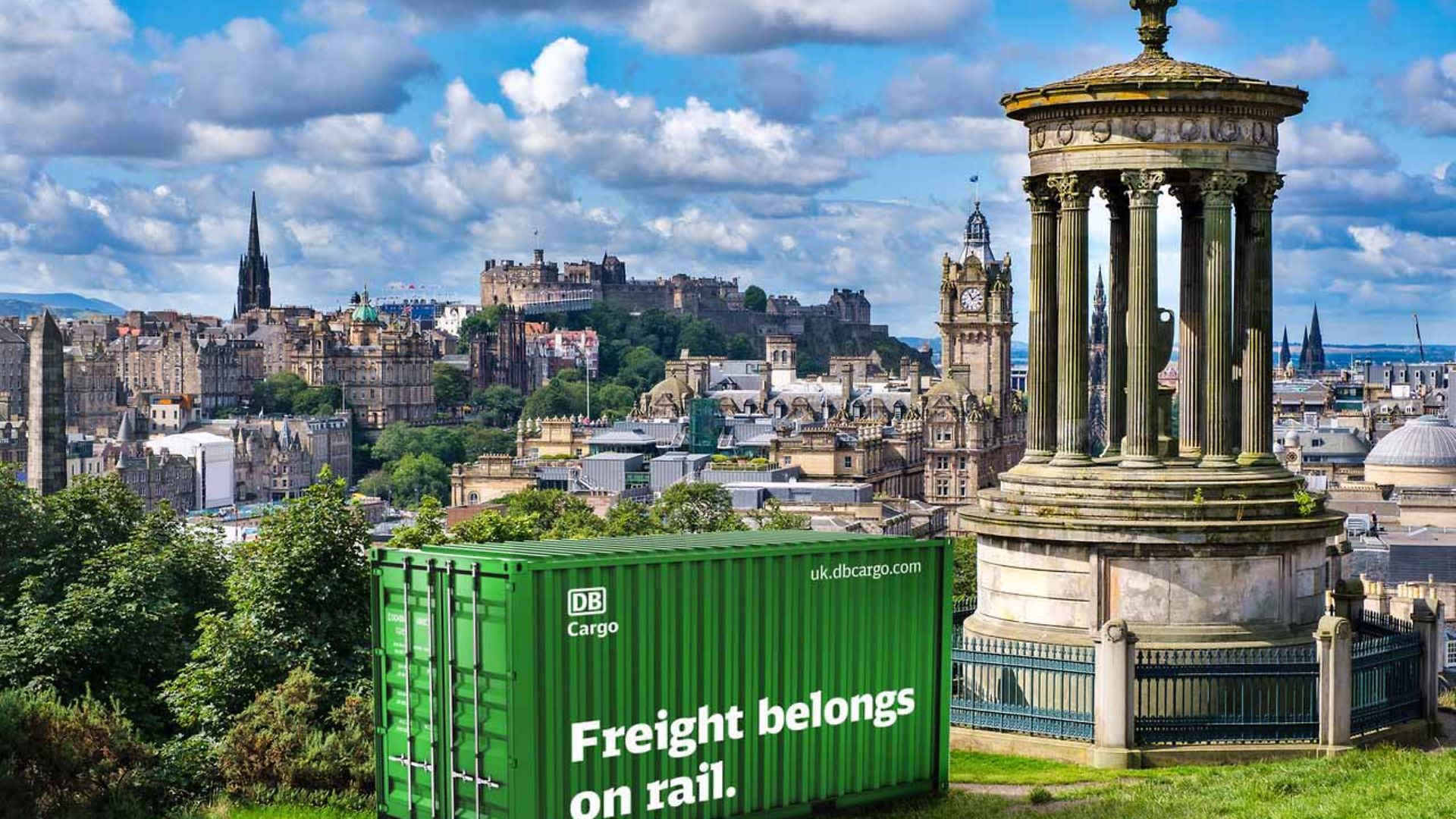 Green DB Cargo container labelled Freight belongs on rail is parked in Edinburgh.