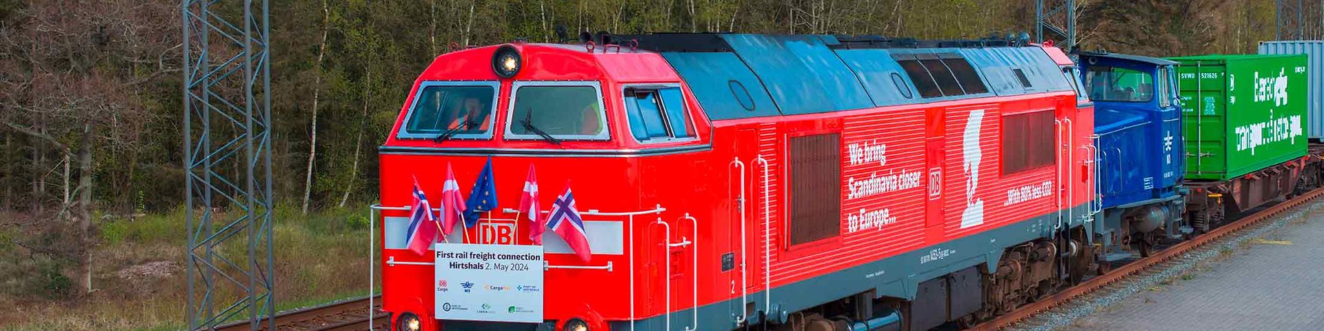 Freight train on trial run to Hirtshals running with Norwegian, Danish and EU flags.