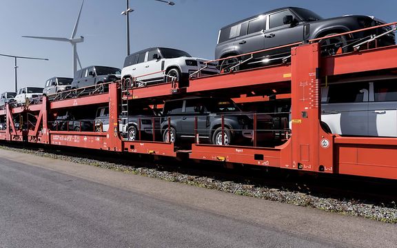 Double-decker wagons loaded with Defenders