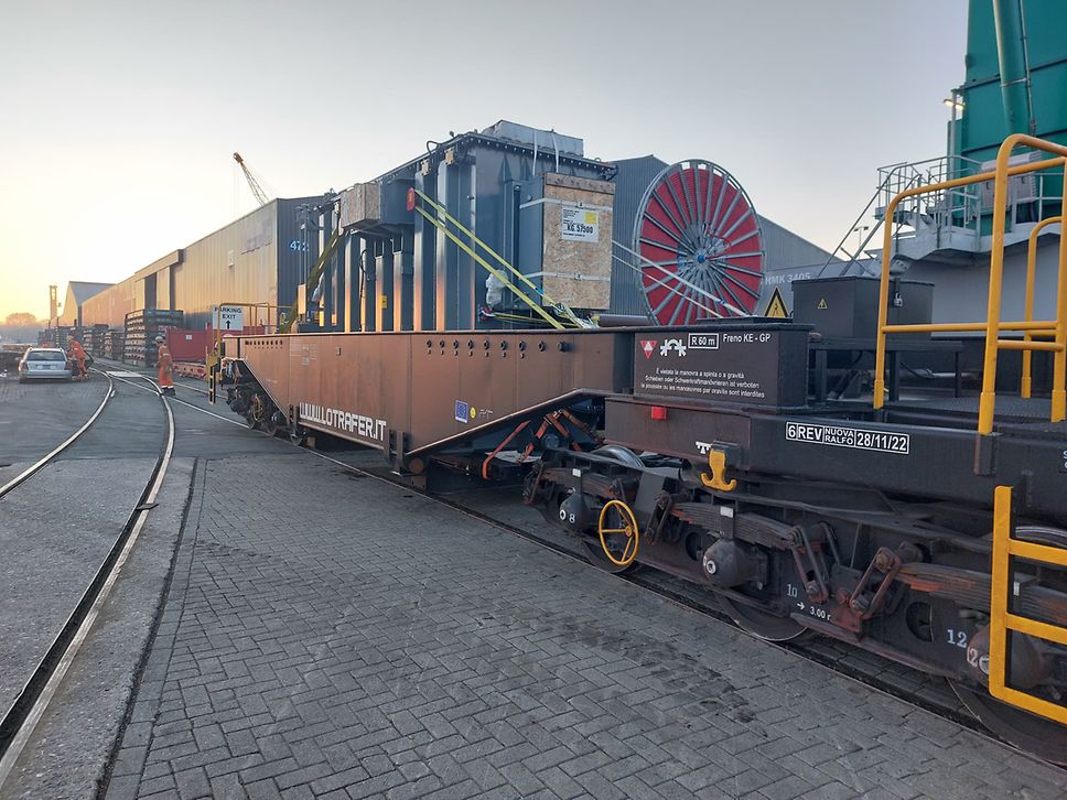 A transformer on a DB Cargo low loader wagon.