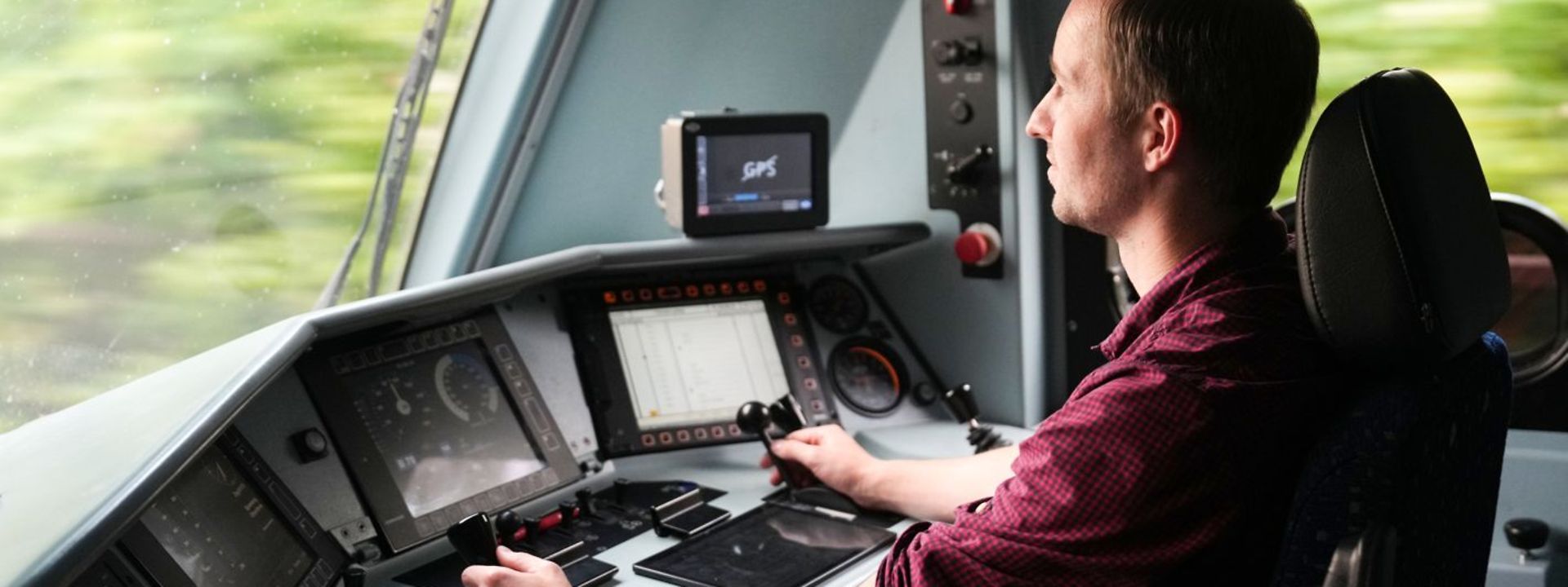 Train driver sits in the cab of a locomotive and drives the train.