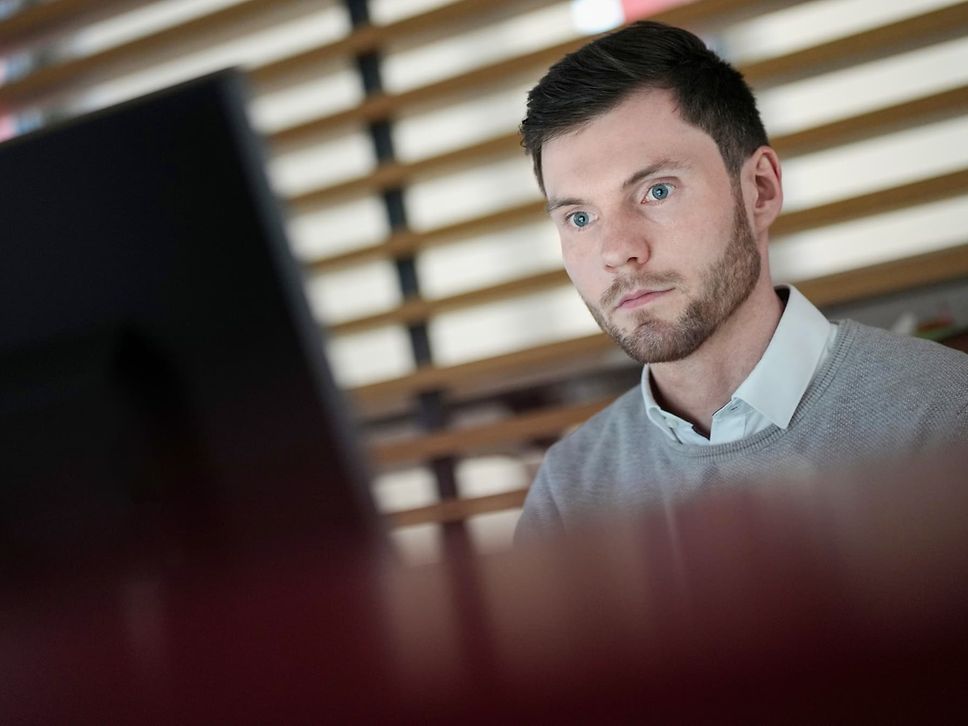 An employee in front of a computer screen