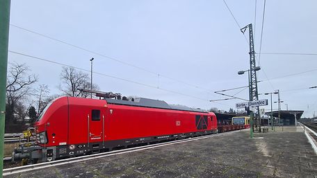 Red DB Cargo locomotive pulling an S-Bahn train