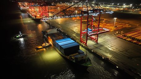 A bird's eye view of a ship loading at JadeWeserPort at night