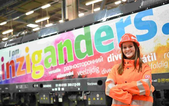 Diversity locomotive with friendly lady in workwear