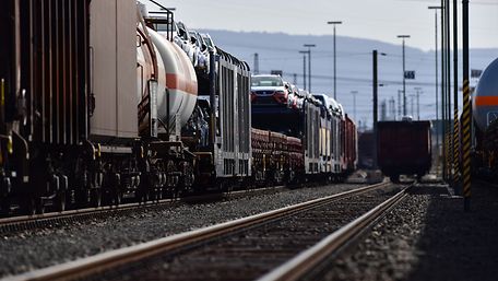 Various freight cars are coupled to a track.